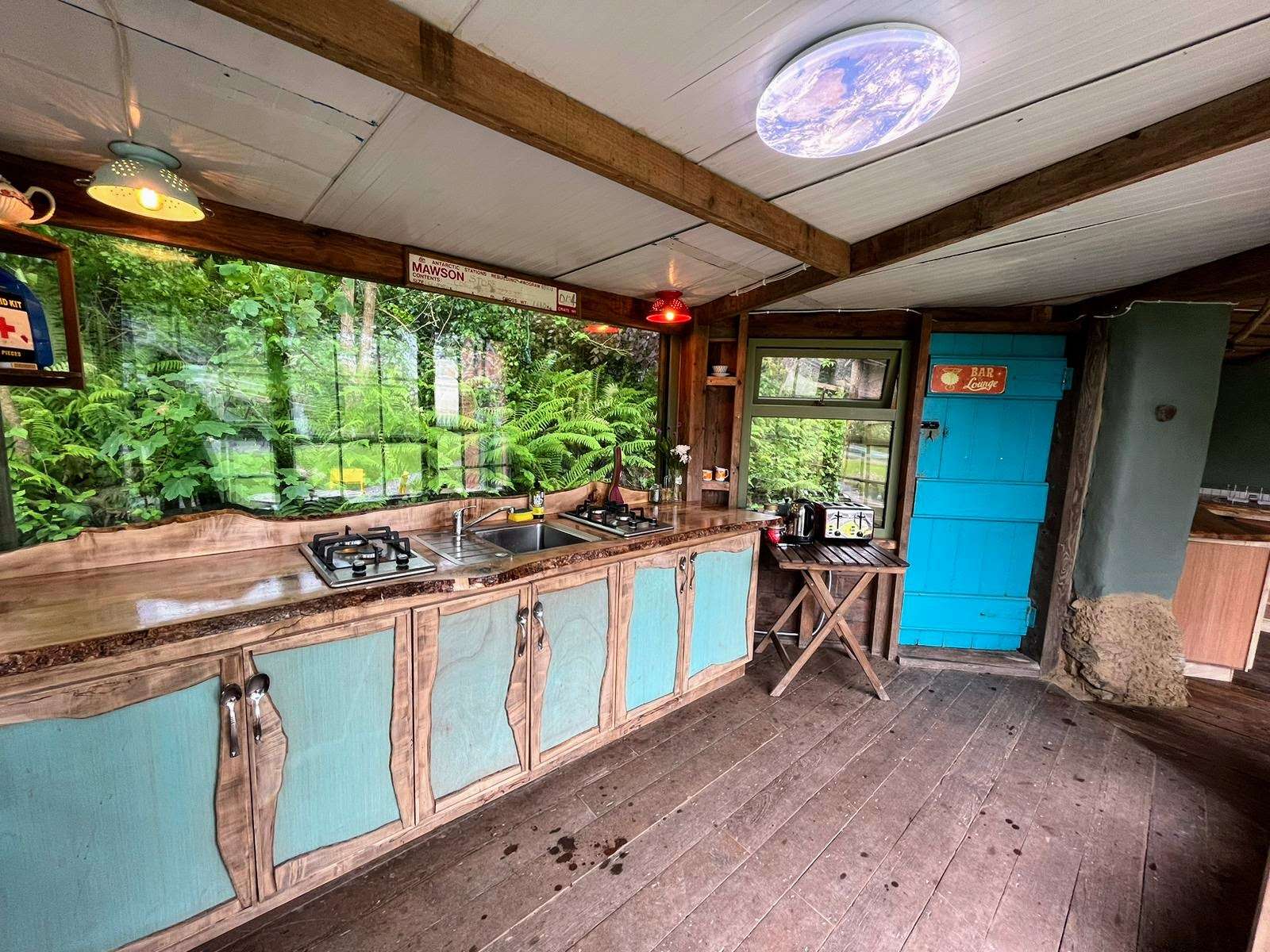Communal kitchen with banquet dining area at Inch Hideaway